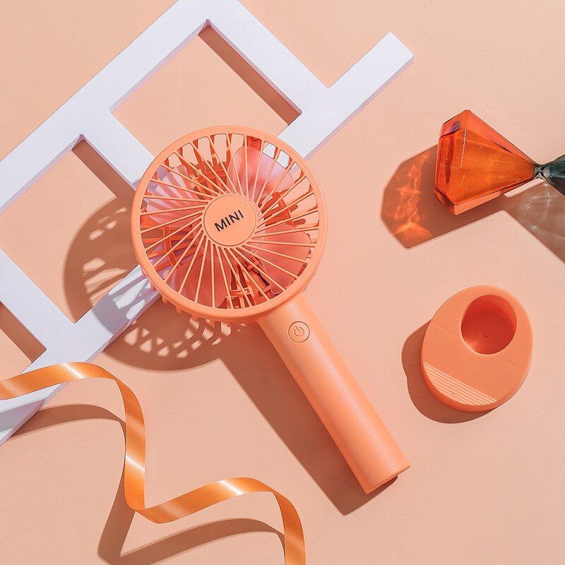 Portable mini fan Students hold a small fan desktop and hold a USB small fan