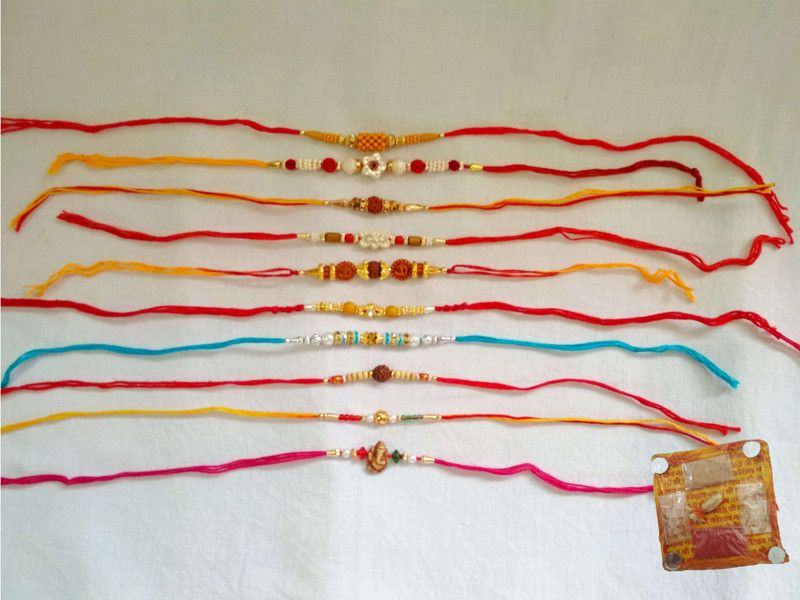 RK18022 Rakhi Set  (10 Ethnic Rakhis of diff. varieties along with 2 packs of Roli Chaval in 2 Elegant Ethnic Potli bags for Gifting Purpose.)