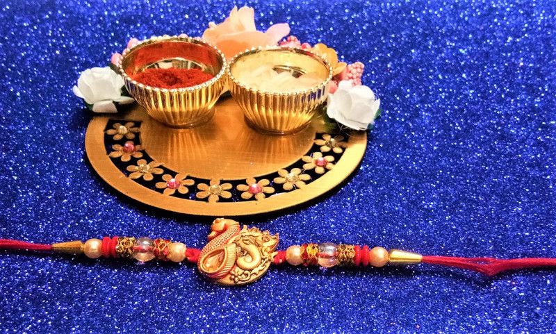 Rakhi, Thali, Chawal Roli Pack Set  (1 rakhi; 1 decorated small thali with two cups attached for chawal and roli; roli chandan chawal and mishri pack)