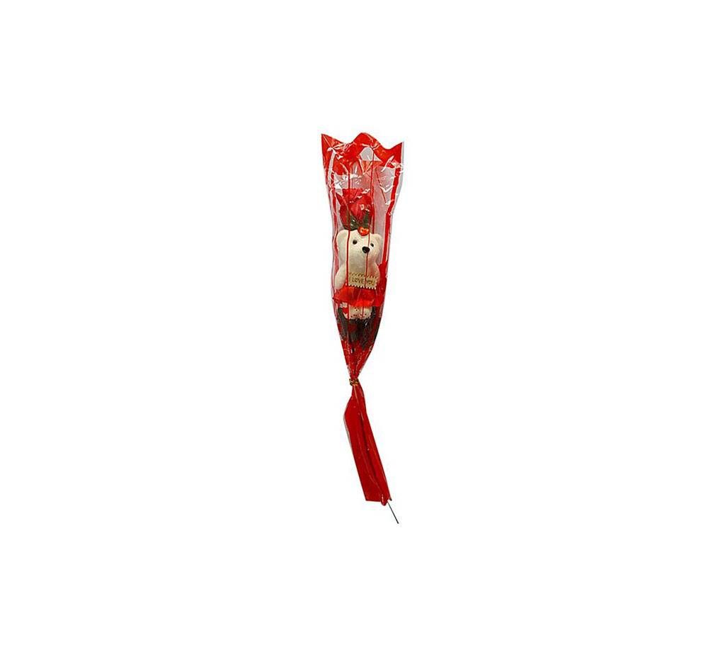 Small teddy bear with red soap rose