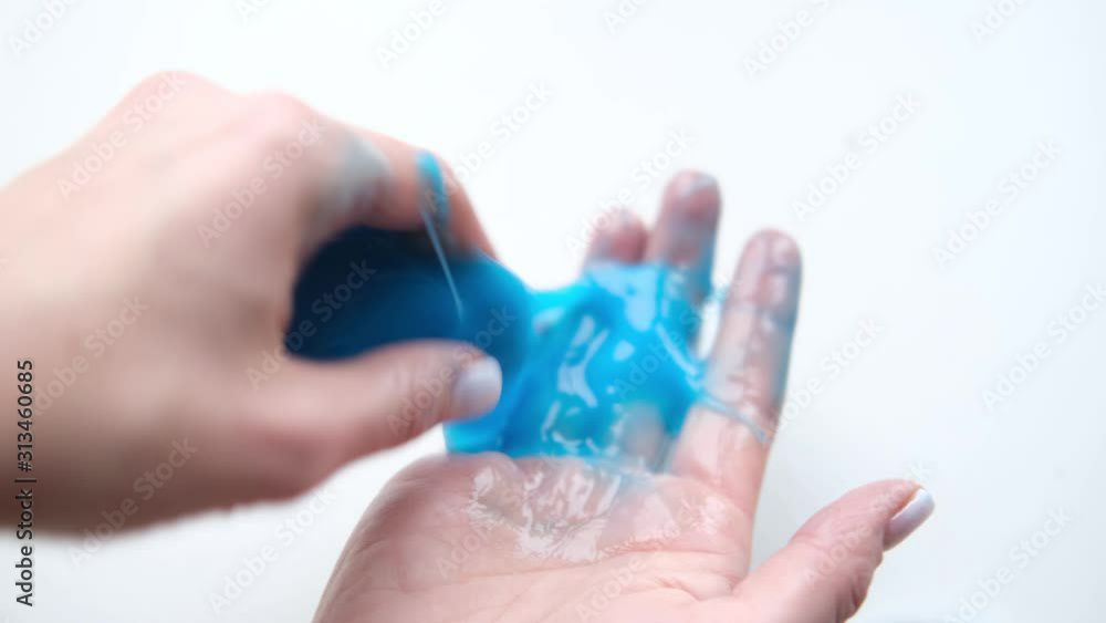 1 x hands playing slime toy. Trendy liquid toy sticks to hands and fingers.